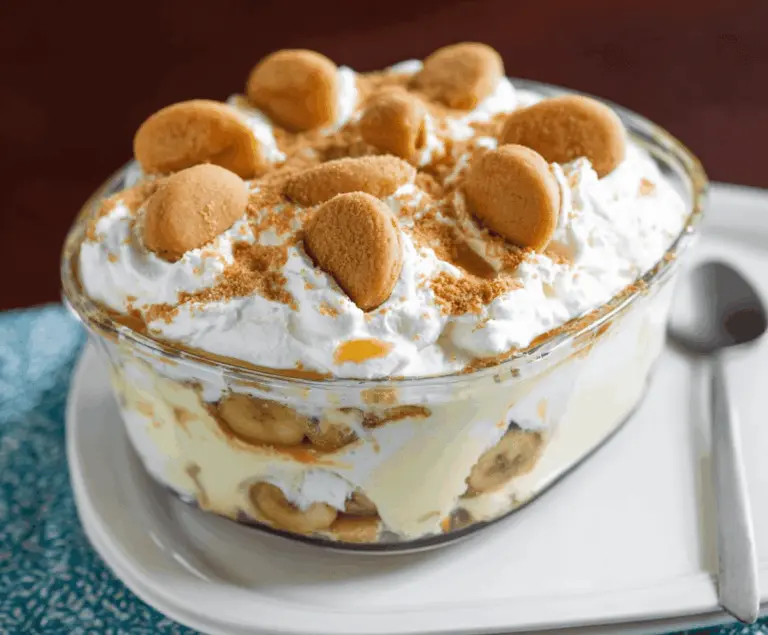 Delicious Banana's Foster Banana Pudding topped with caramelized bananas and whipped cream, perfect for dessert lovers.