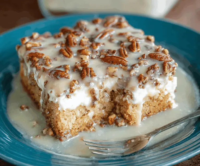 Delicious Butter Pecan Praline Poke Cake topped with caramelized pecans and creamy butter frosting, perfect for dessert indulgence.