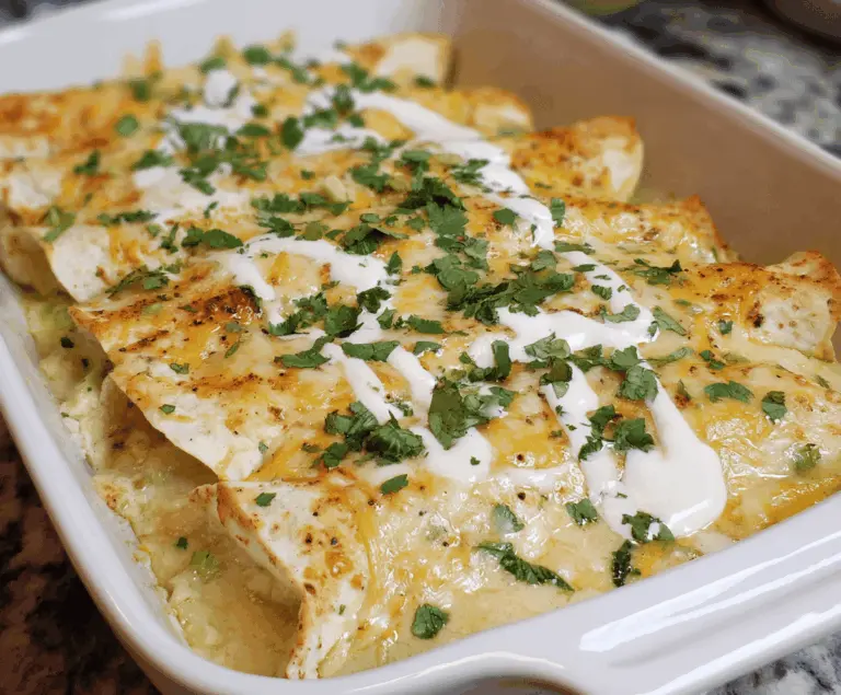 Creamy low carb white chicken enchiladas topped with melted cheese and fresh cilantro on a plate, perfect for a healthy dinner