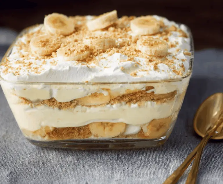 Delicious No-Bake Southern Banana Pudding layered with creamy custard, fresh bananas, and whipped topping in a glass serving dish