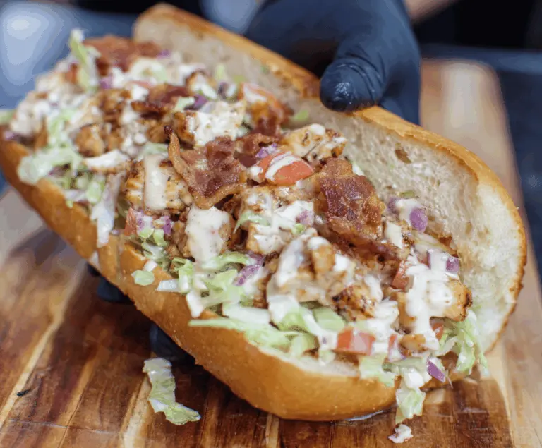 Delicious chopped chicken bacon ranch sandwich with fresh lettuce, tomato, and melted cheese on toasted bread