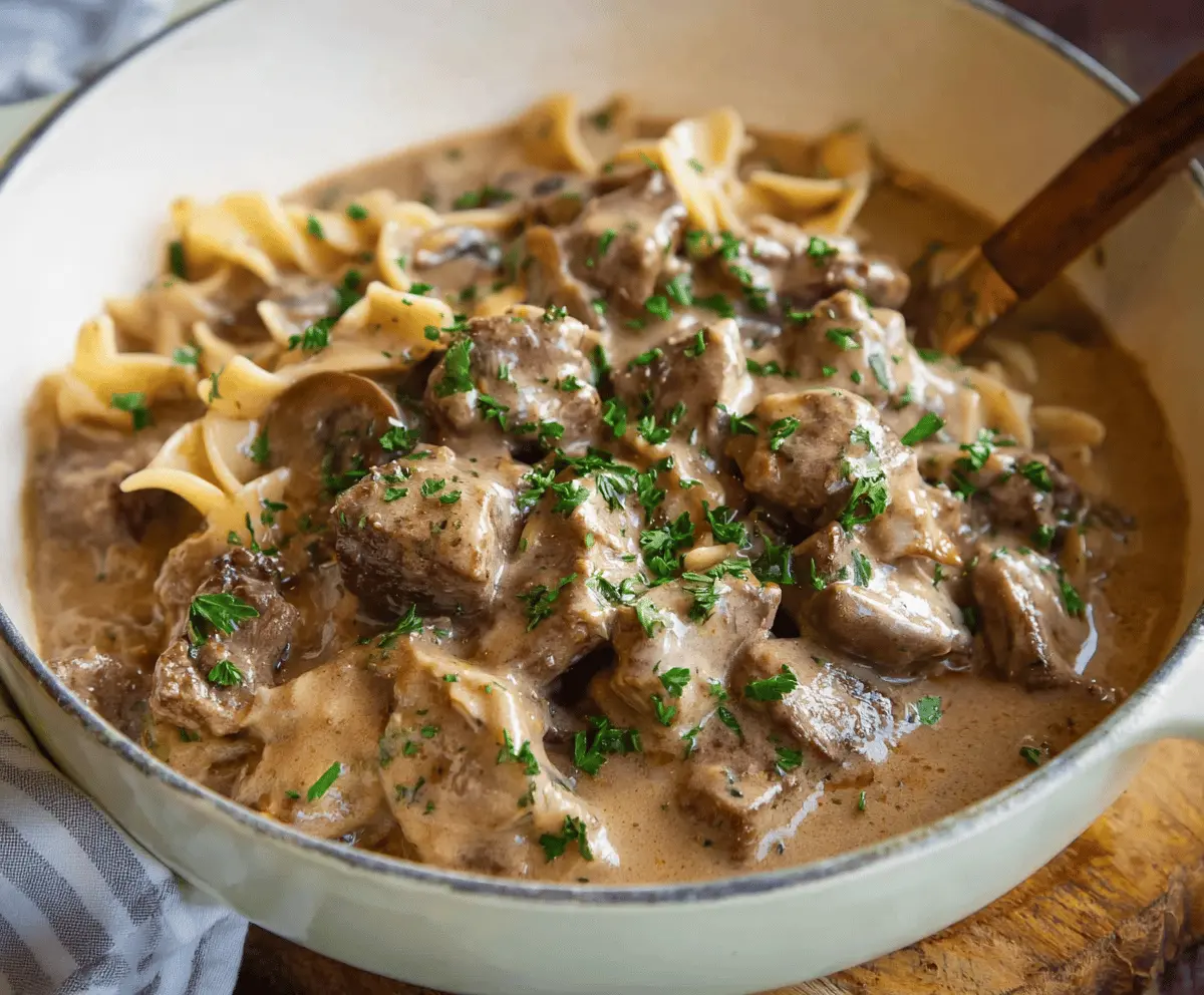 Creamy slow cooker beef stroganoff stew with tender beef, mushrooms, and savory sauce served in a bowl