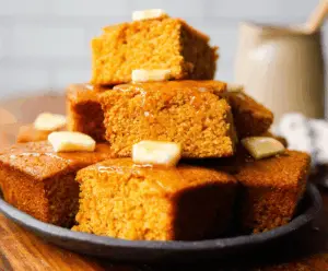 Golden Honey Butter Sweet Potato Cornbread served on a rustic plate, highlighting its moist texture and sweet flavor.