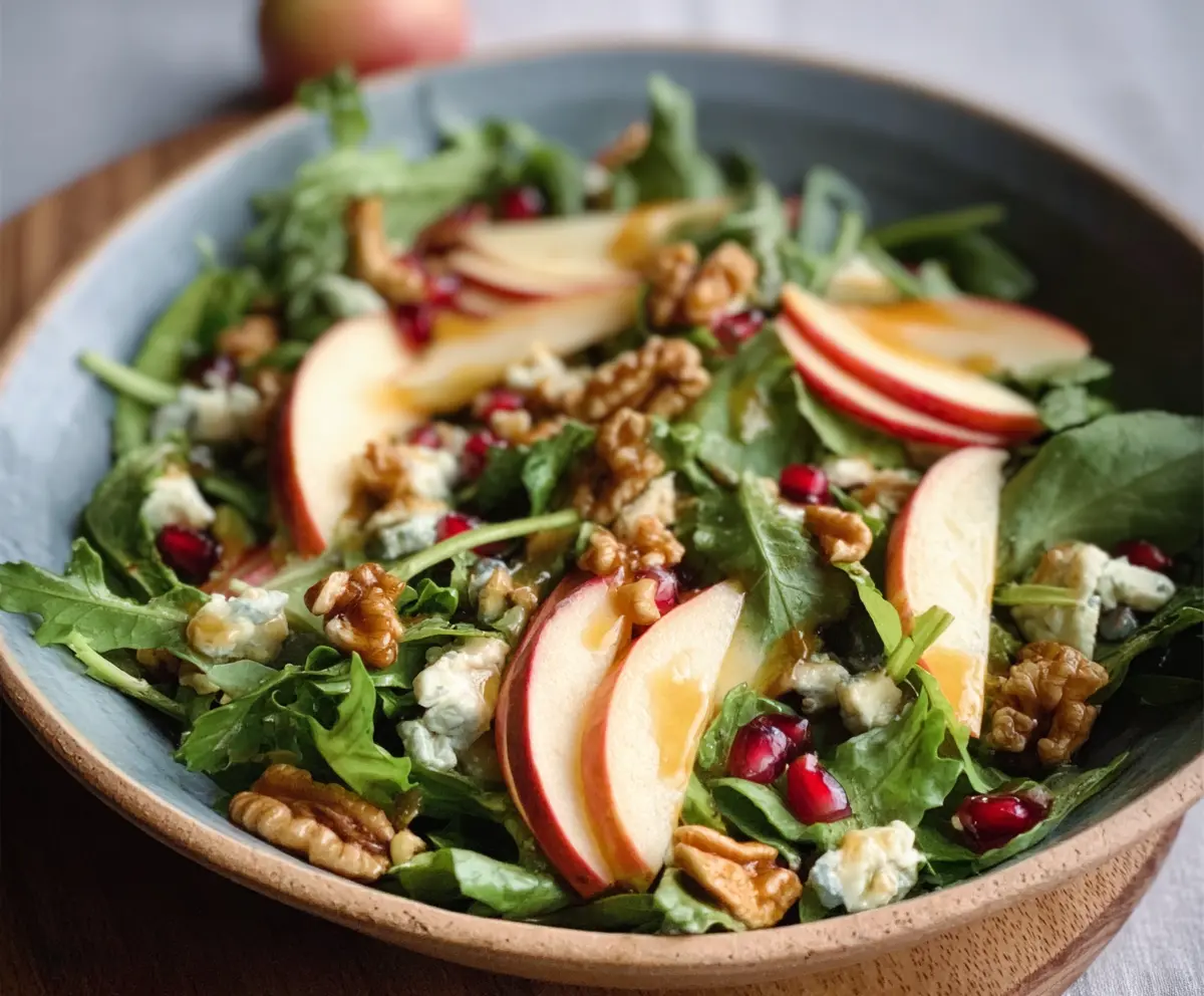 Fresh Honeycrisp Salad with mixed greens and walnuts in a bowl, perfect for a healthy snack or light meal.