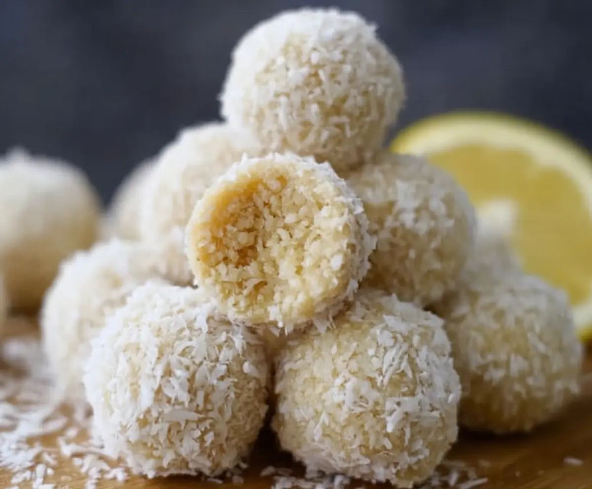 Delicious Lemon Coconut Protein Balls on a wooden plate, perfect for a healthy snack