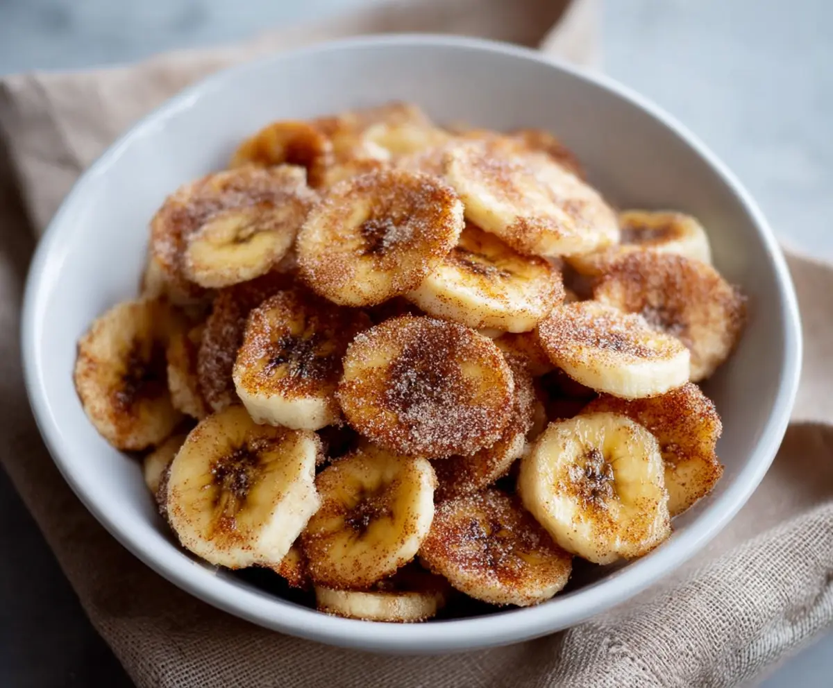 Crispy homemade cinnamon banana chips cooked in an air fryer for a healthy snack.