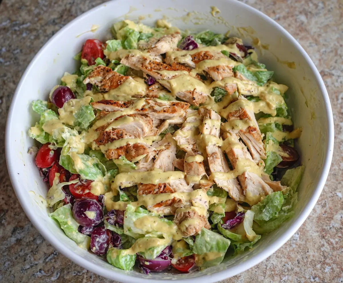 Close-up of Honey Mustard Chicken Salad without Mayo, featuring fresh greens, tender chicken, and a drizzle of honey mustard dressing.