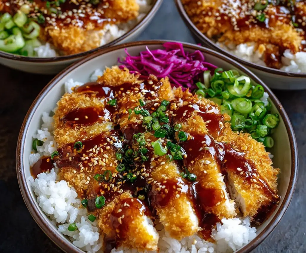 Delicious Japanese Katsu Bowl featuring crispy breaded pork cutlet drizzled with savory Tonkatsu sauce.