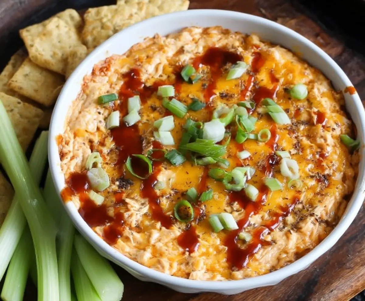 Creamy smoked BBQ chicken dip served with crispy chips, perfect for parties and game day snacks.