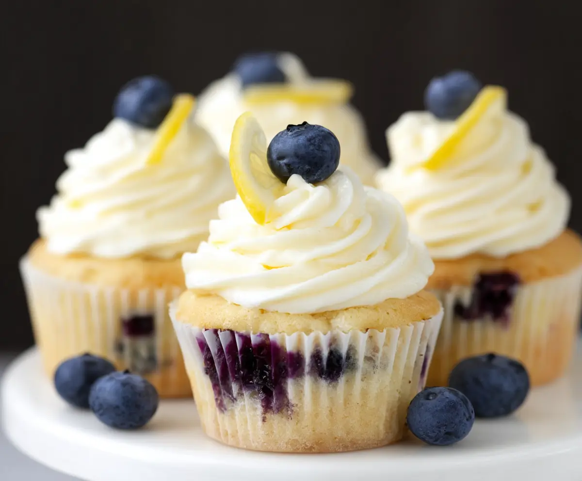 Delicious Lemon Blueberry Cupcakes topped with fresh blueberries and lemon zest.