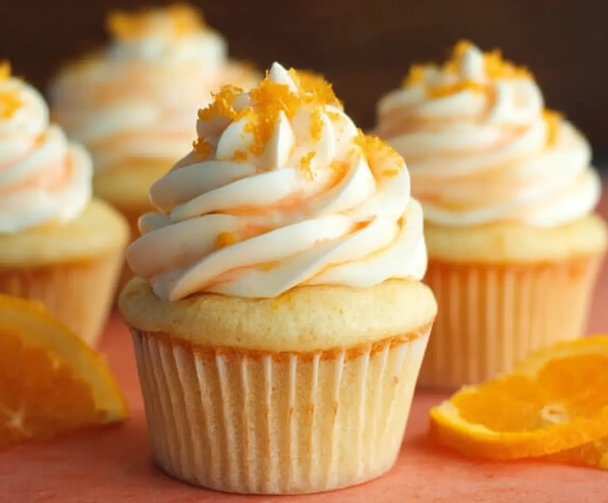 Delicious Orange Creamsicle Cupcakes topped with creamy frosting and orange zest.