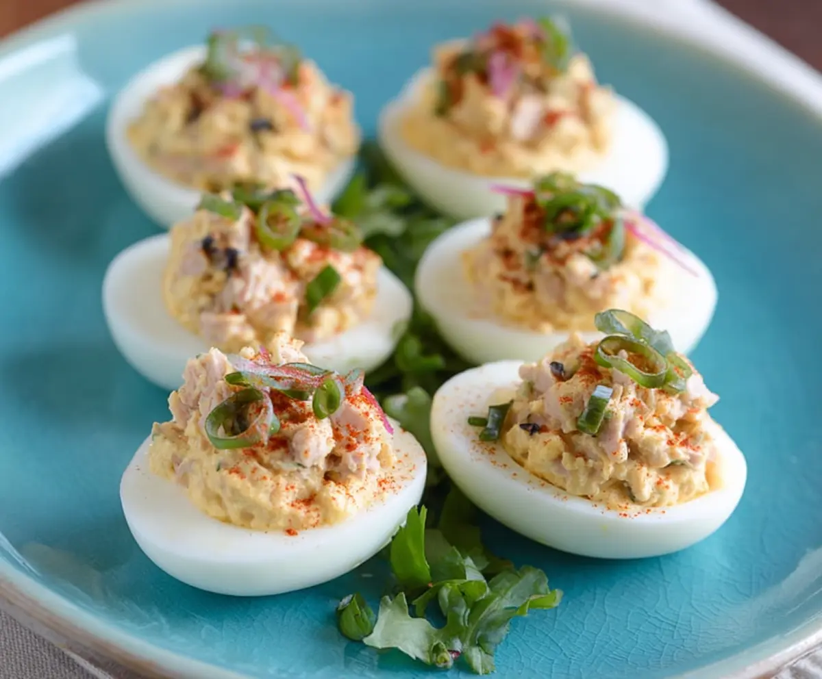 Delicious Tuna Deviled Eggs garnished with herbs, perfect for appetizers and party snacks